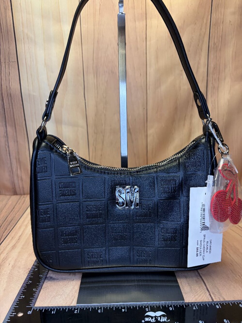 Sleek black Steve Madden shoulder bag featuring an all-over embossed square logo